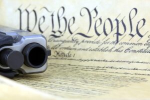 Contract beneath a gun depicting restoration of the gun rights in Indianapolis