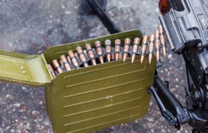 Machine gun beside a box full of ammunition