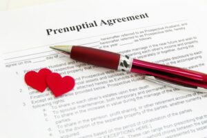 Image of pen and 2 heart cutouts on prenuptial agreement form in Indianapolis