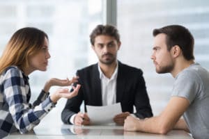 Couple arguing about divorce settlement in front of a lawyer in Indiana